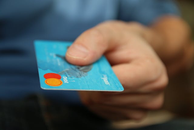 blue debit card Customer interacting with staff at a car rental counter