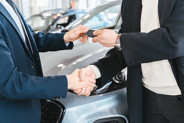 Car keys being handed over during a vehicle rental transaction