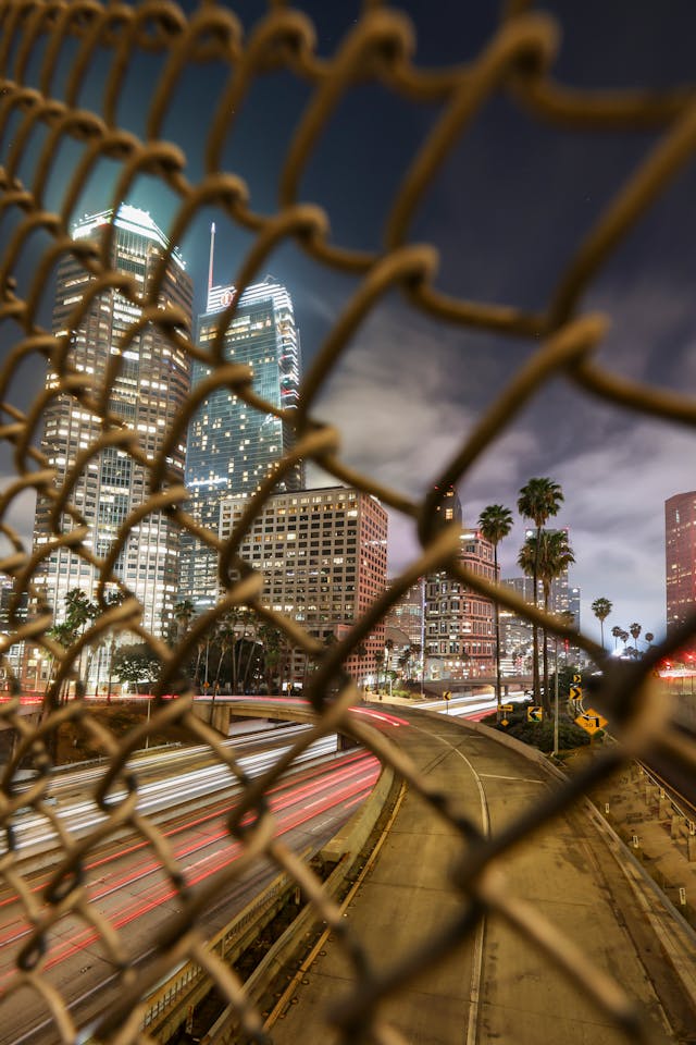 Vehicles traveling on a Los Angeles freeway during evening.