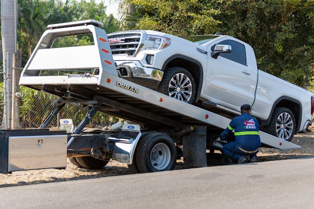 tow truck picking up car after accident